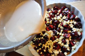 Pour batter evenly over cherries and chocolate - Food Gypsy